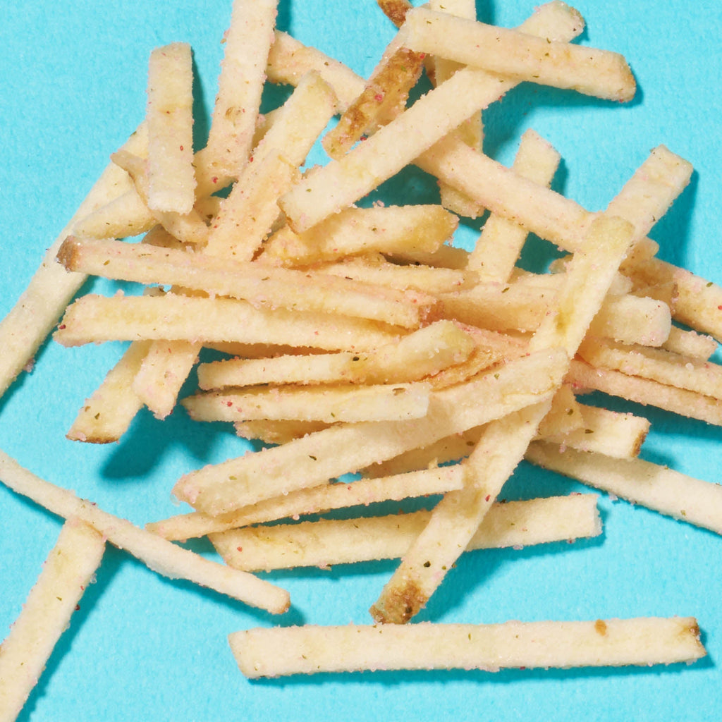 A pile of thin, crispy French fries on a bright blue background, evoking the unique treats from the Bokksu Snack Box: Seasons of Japan.